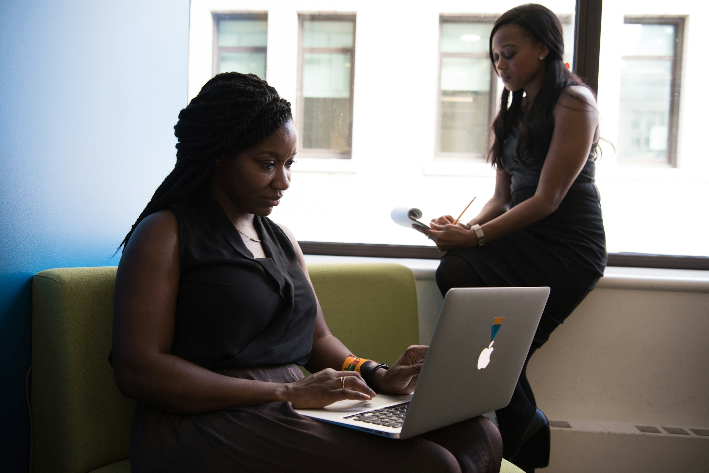 woman sitting on a sofa and using a laptop - Agentic Meaning