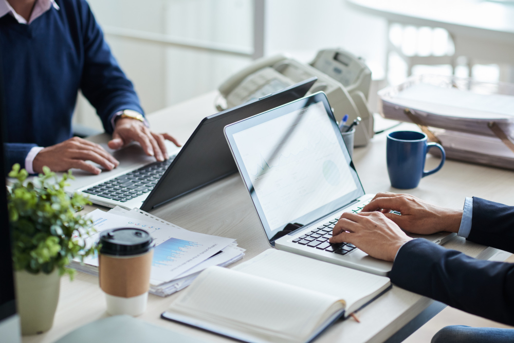 employees working on a laptop - Workflow Automation for Small Business