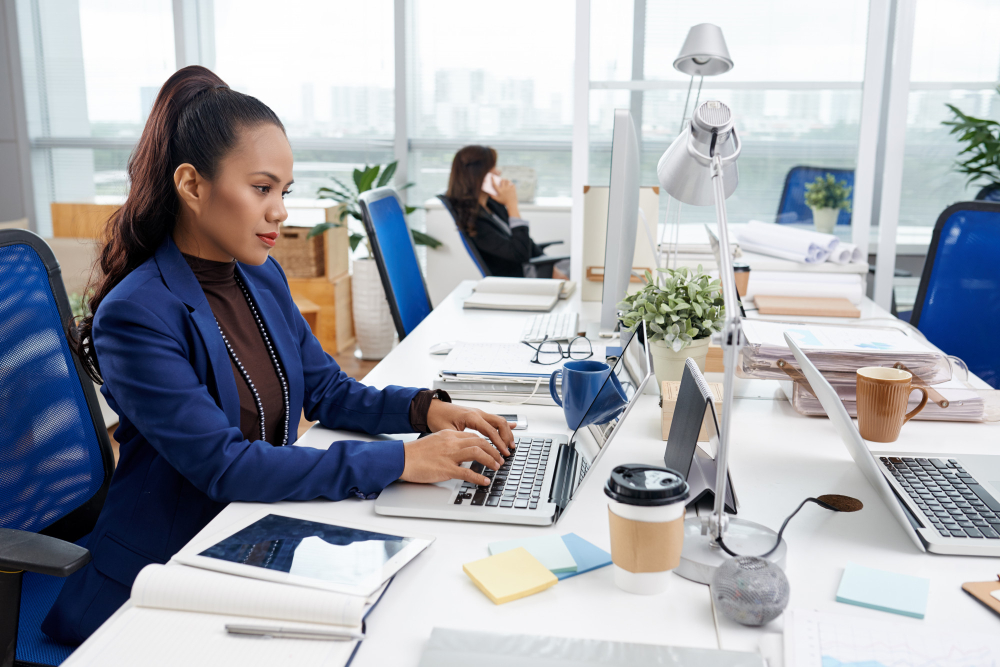 woman typing on a keyboard - What Is an AI Agency