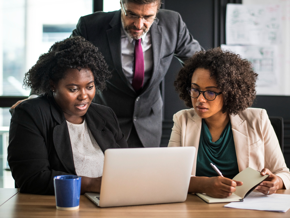 employees having a meeting - What Is an AI Agency