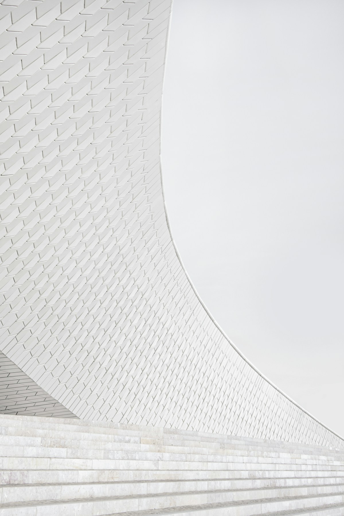 Curved tiled facade and steps at the MAAT museum in Lisbon