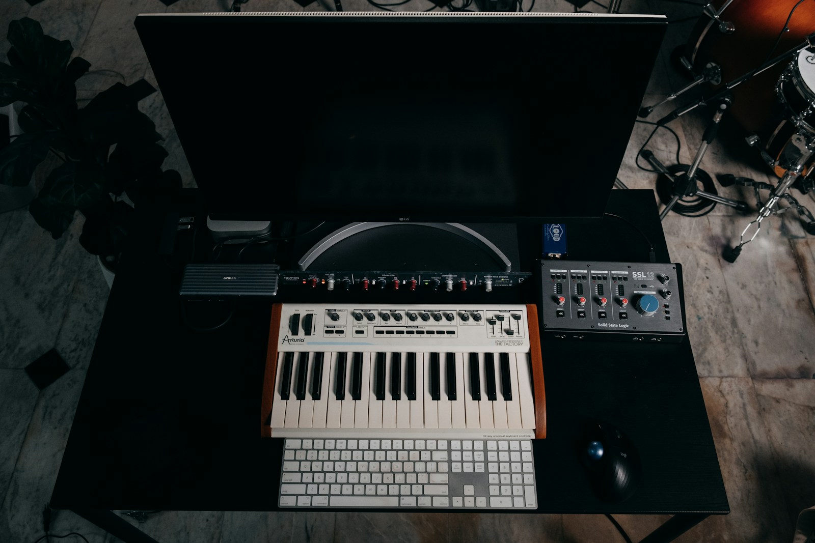 Synthesizer and production equipment on a studio desk