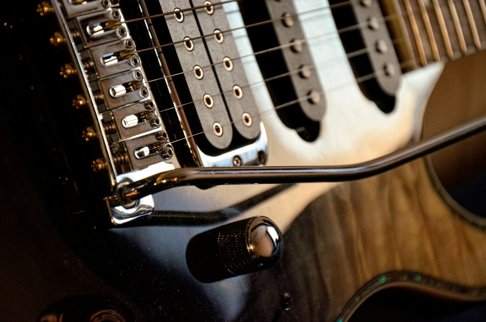 Close view of an electric guitar bridge and strings