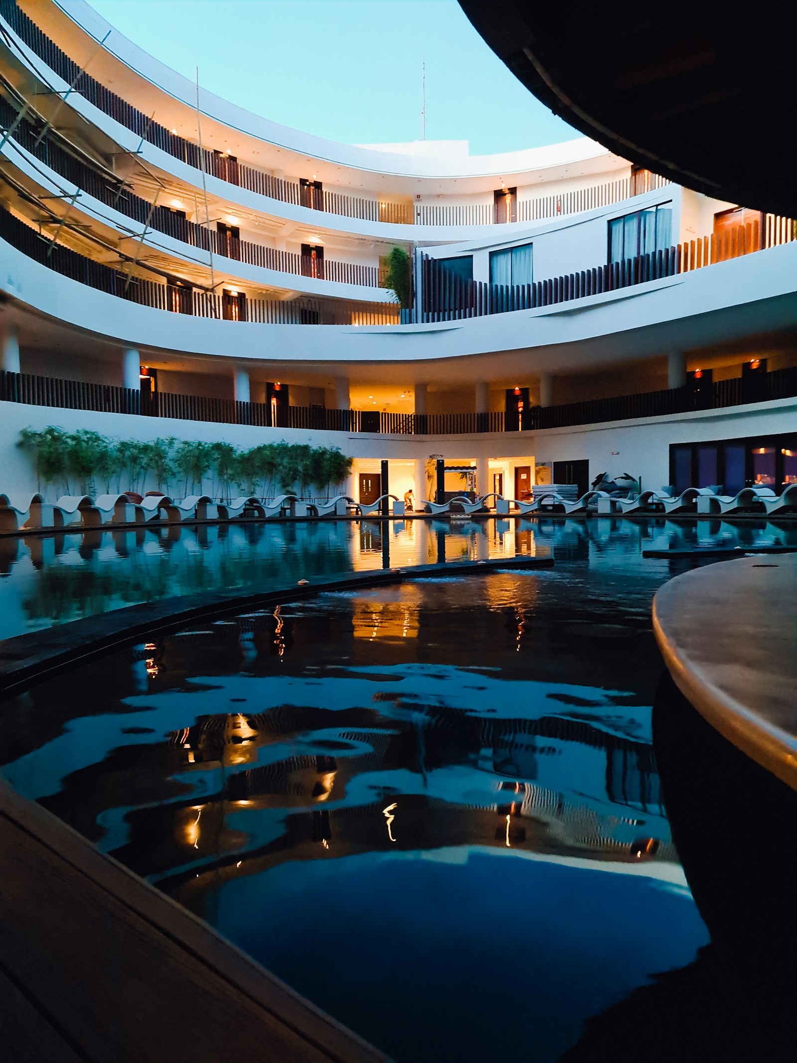 Illuminated courtyard pool at an independent hospitality property