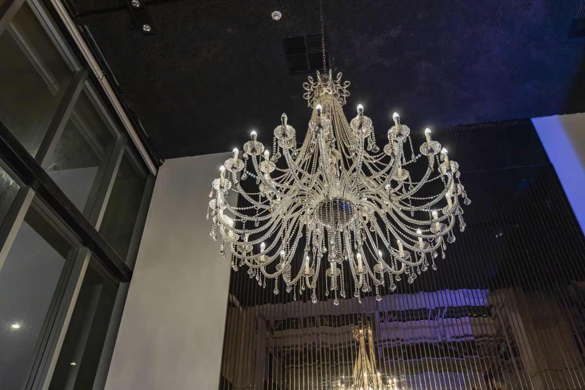 Crystal chandelier illuminating an elegant evening banquet hall