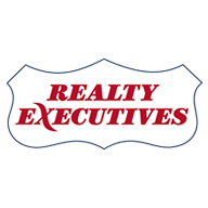 EXIT logo with stylized house roofs beneath the bold uppercase letters.