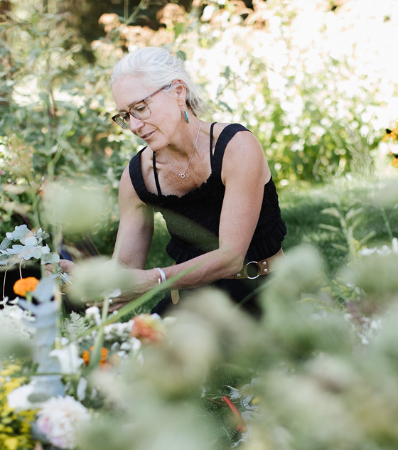 Woman looking at plants in a garden