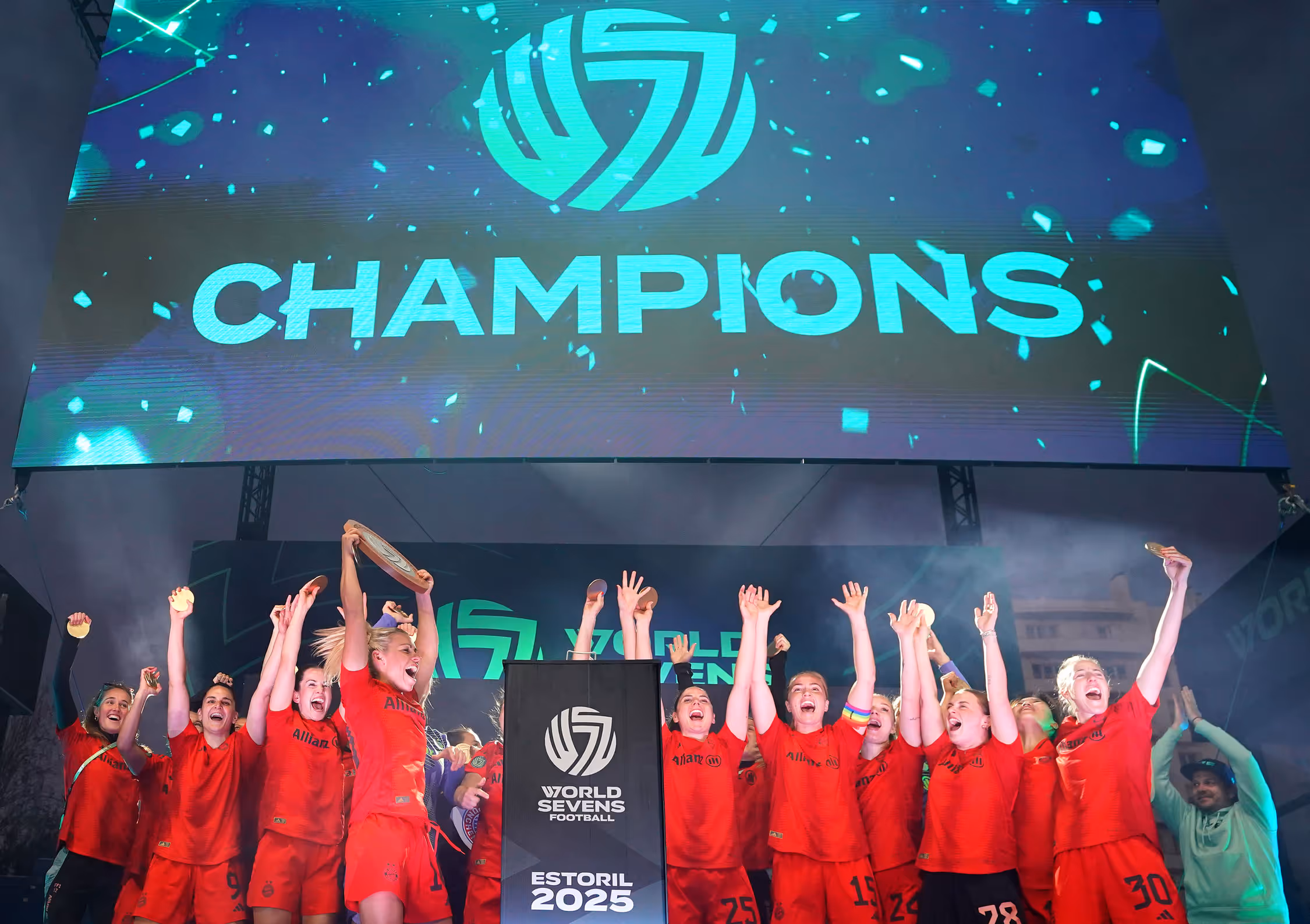 Bayern München win the first ever World Sevens Football kickoff and celebrate on the stage as confetti flys and the trophy is presented