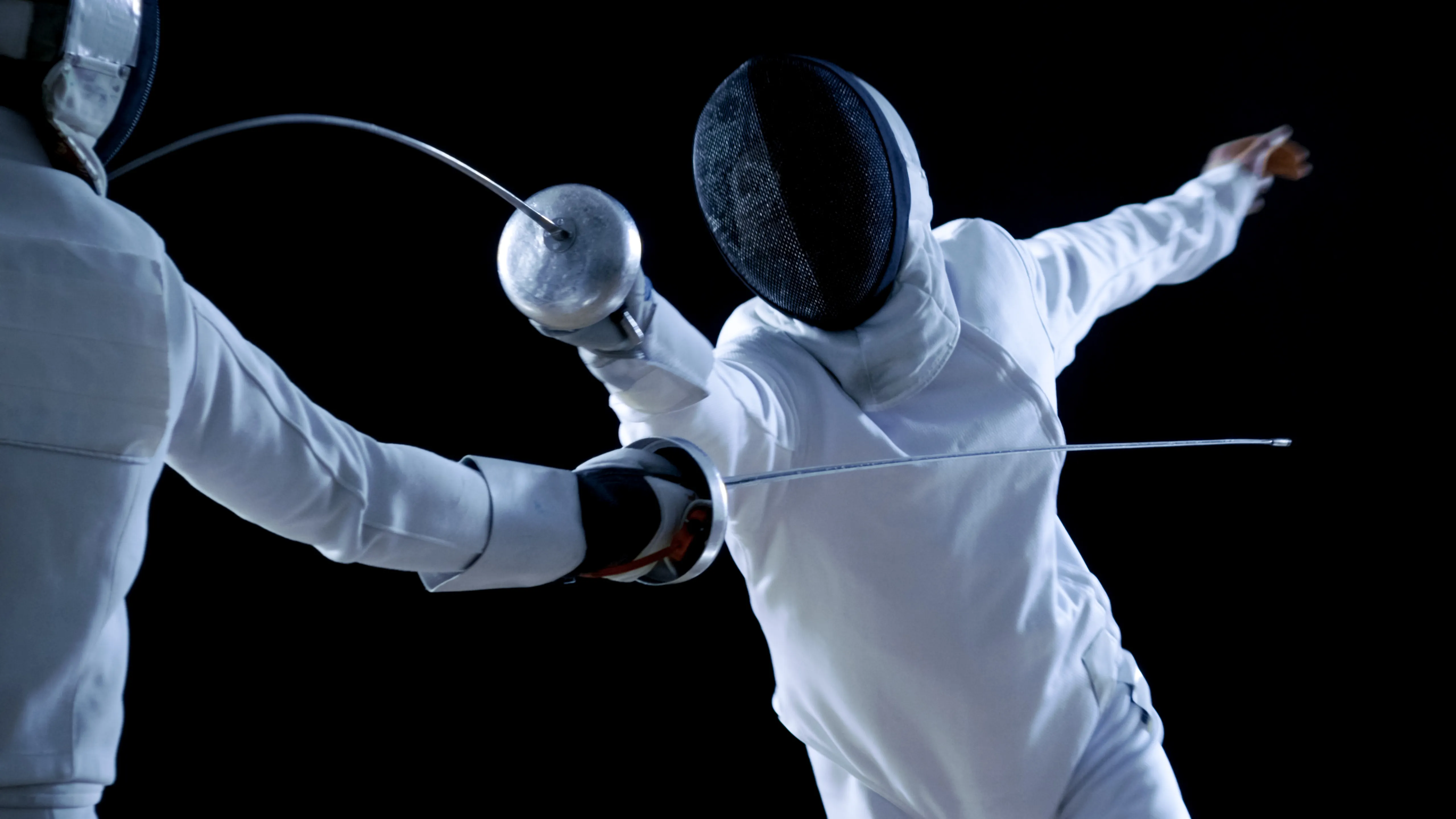 Épée fencers in action at Allez Fencing Club in Watertown, MA—showcasing dynamic movement, precision, and the spirit of modern fencing.