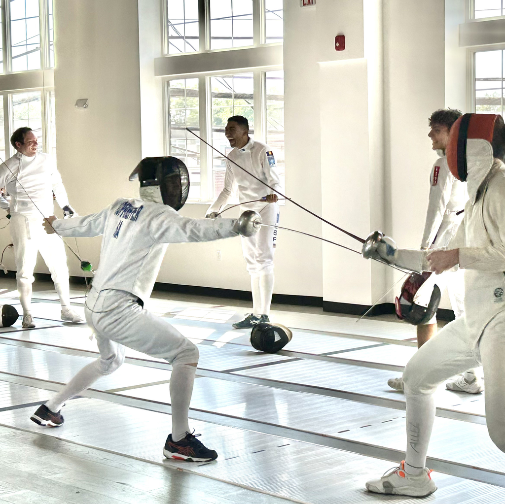 Fencers of all ages and skill levels enjoying a community open fencing session in épée at Allez Fencing Club in Watertown, Massachusetts, practicing together, sharing laughs, and building friendships in a welcoming training space.