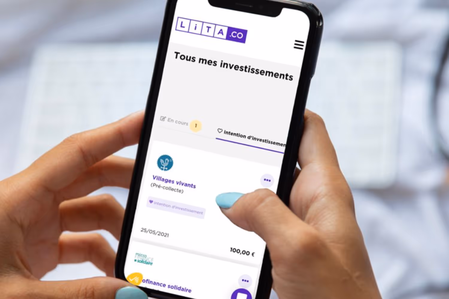 Photo d'un·e investisseur·euse Lita sur son téléphone en train de regarder son portefeuille d'investissement
