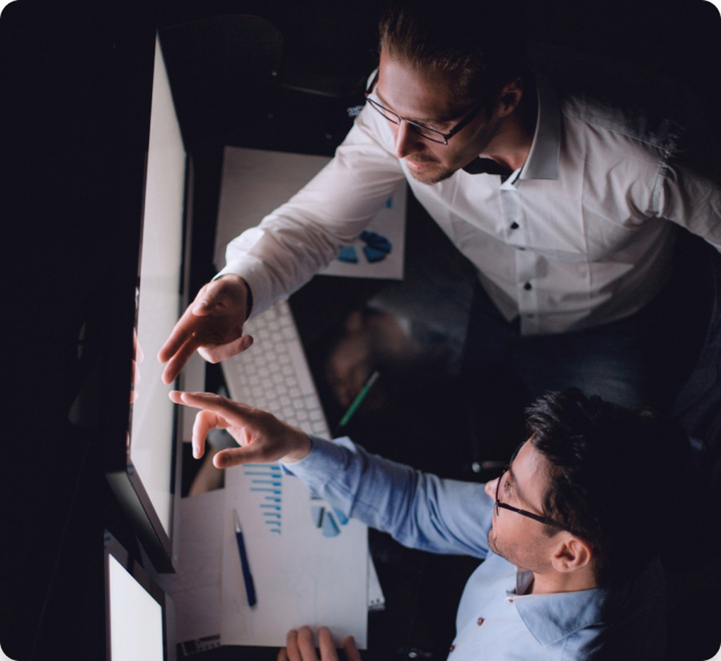 Two colleagues reviewing performance data on screen