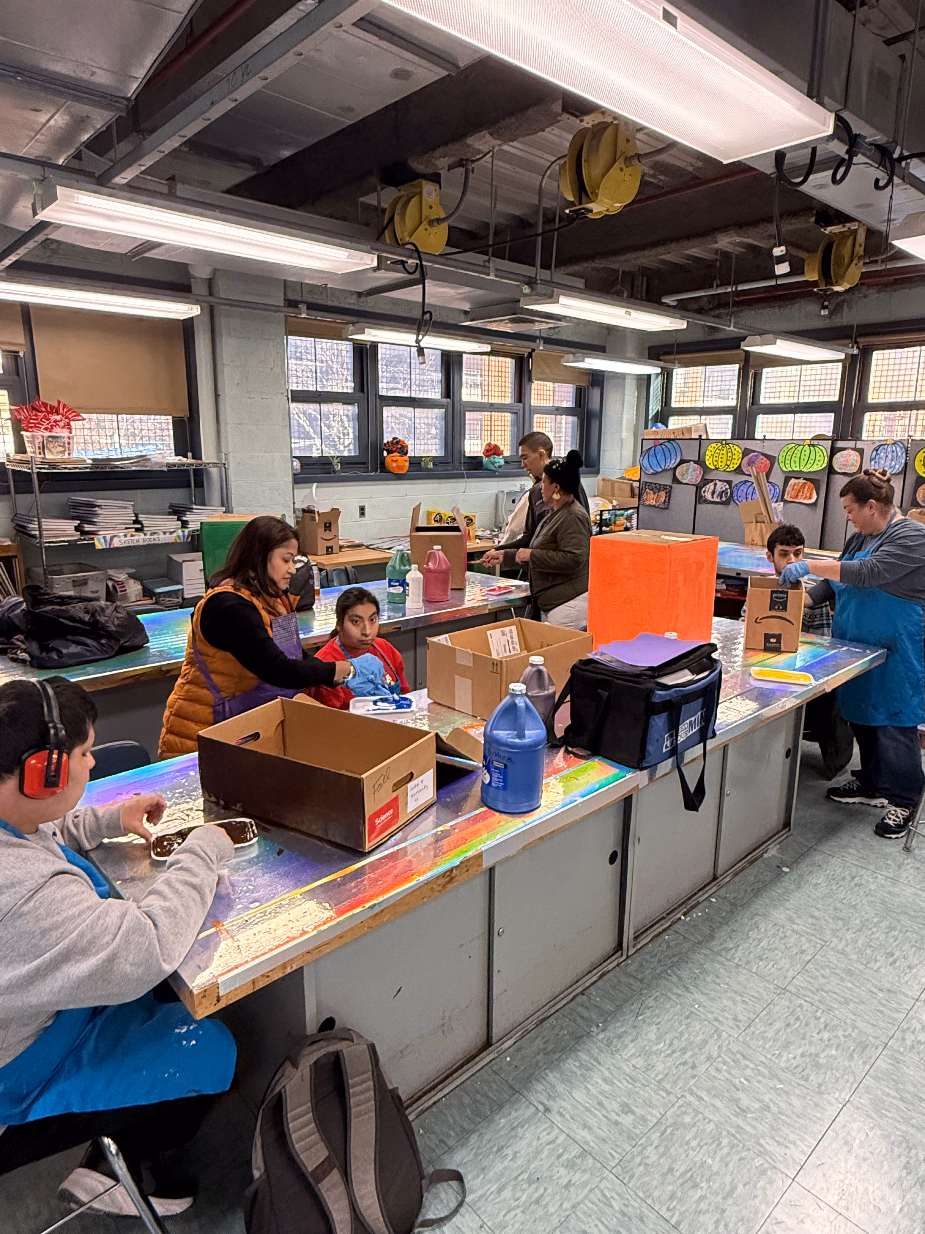 Students and teachers working together in a school art classroom