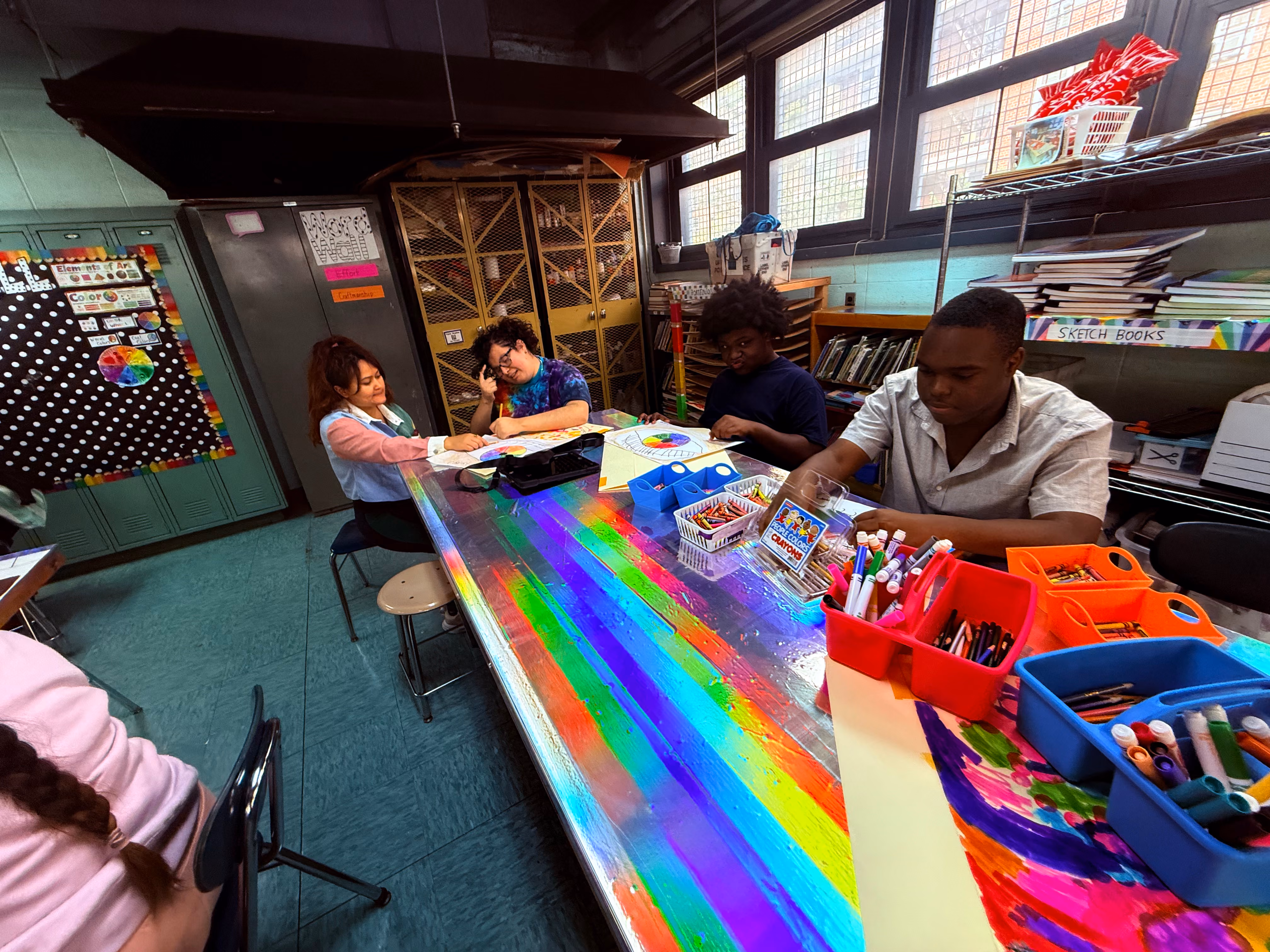 Students working on color wheel art projects in classroom