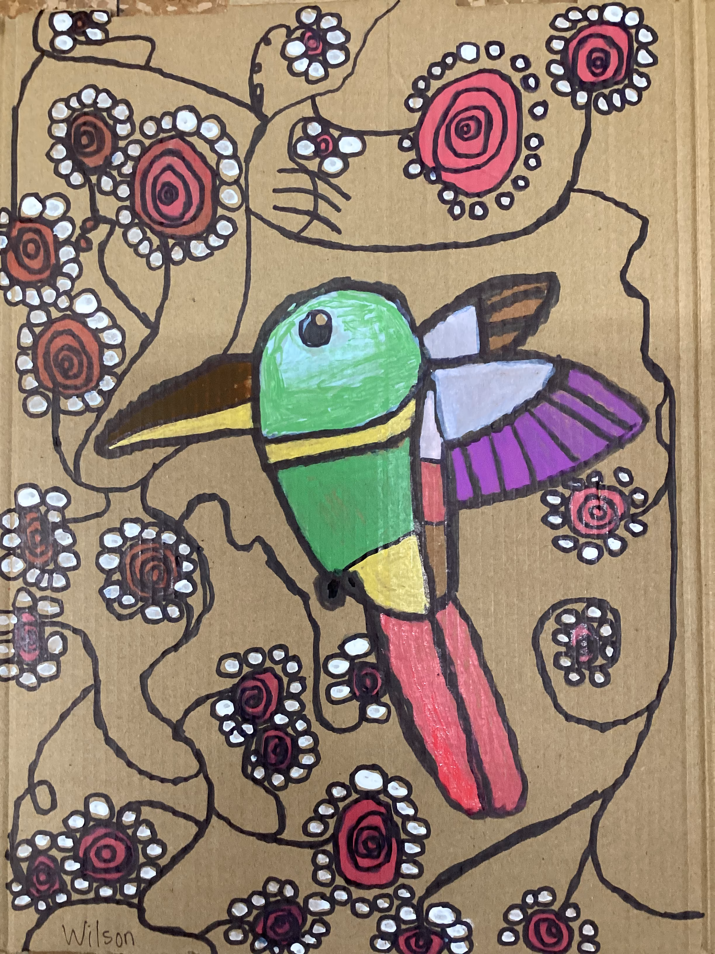Student artwork of a colorful hummingbird among flowers on cardboard