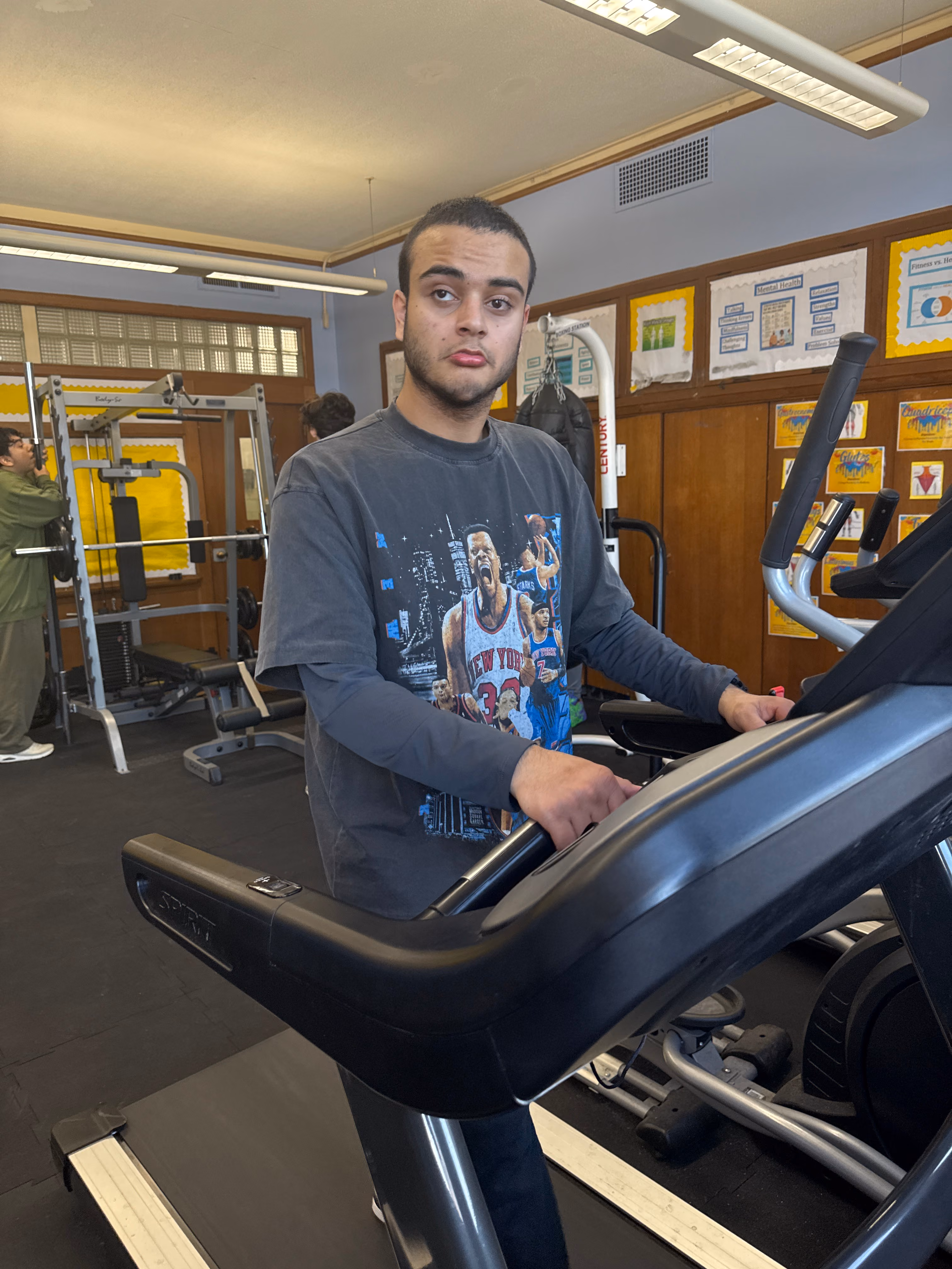 Student using a treadmill in the school fitness room