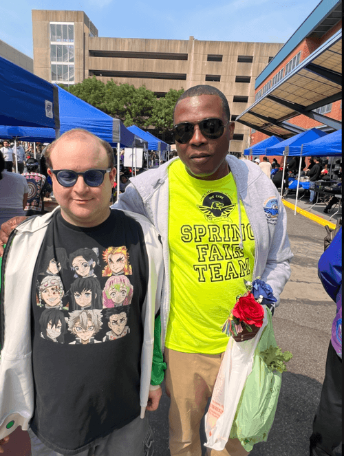 Two attendees posing together at the school spring fair event