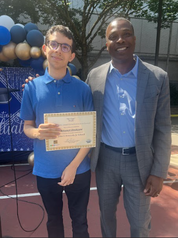 Student receiving award certificate from school principal at ceremony