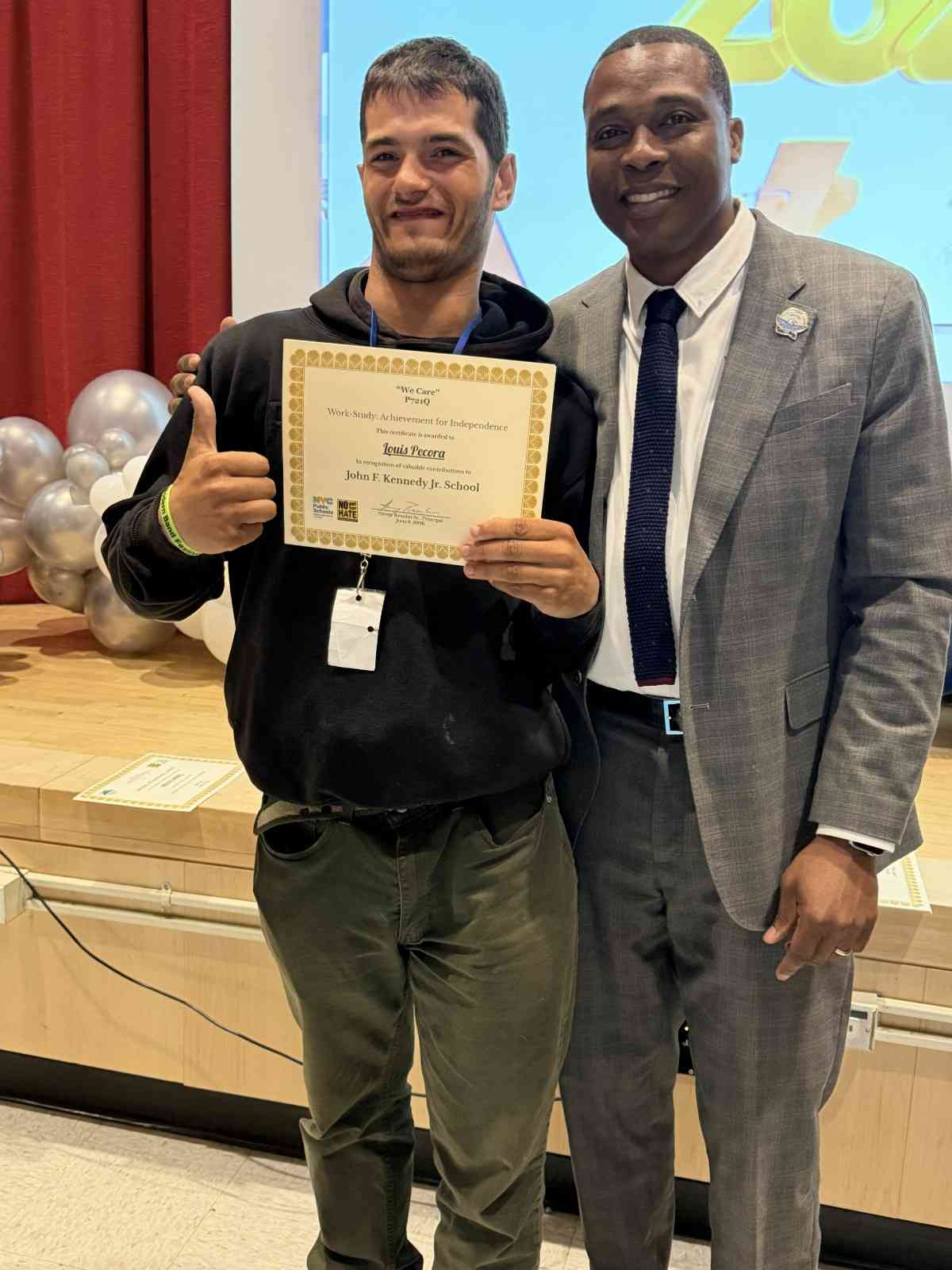 Student receiving award certificate from school principal at ceremony