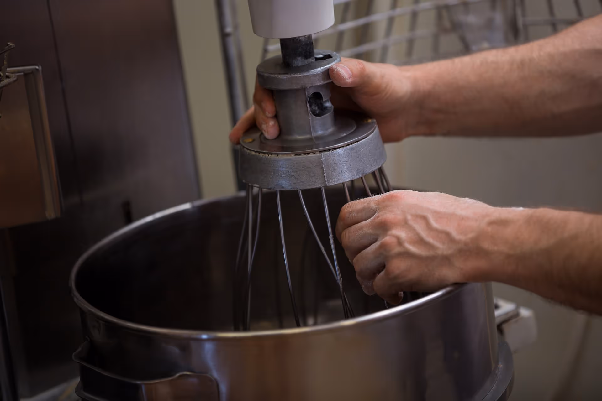 hands of person holding mixer wisk