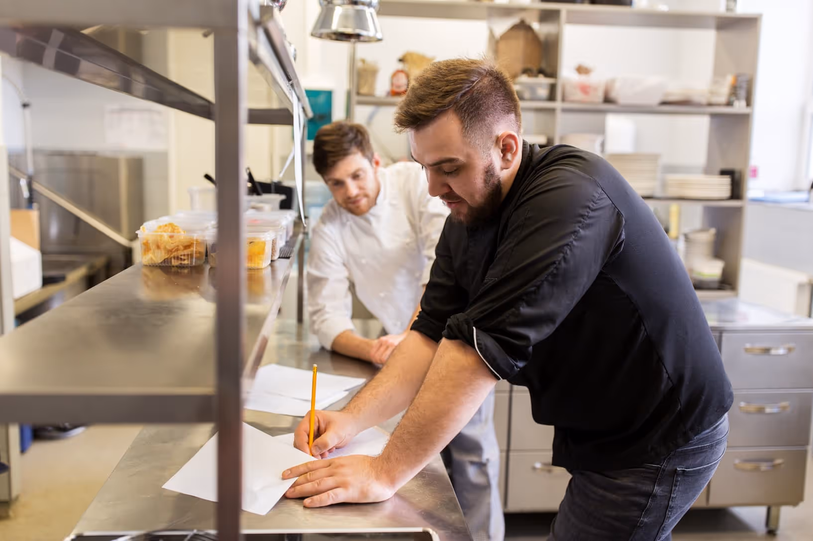 cooking food profession people writing on paper in kitchen setting