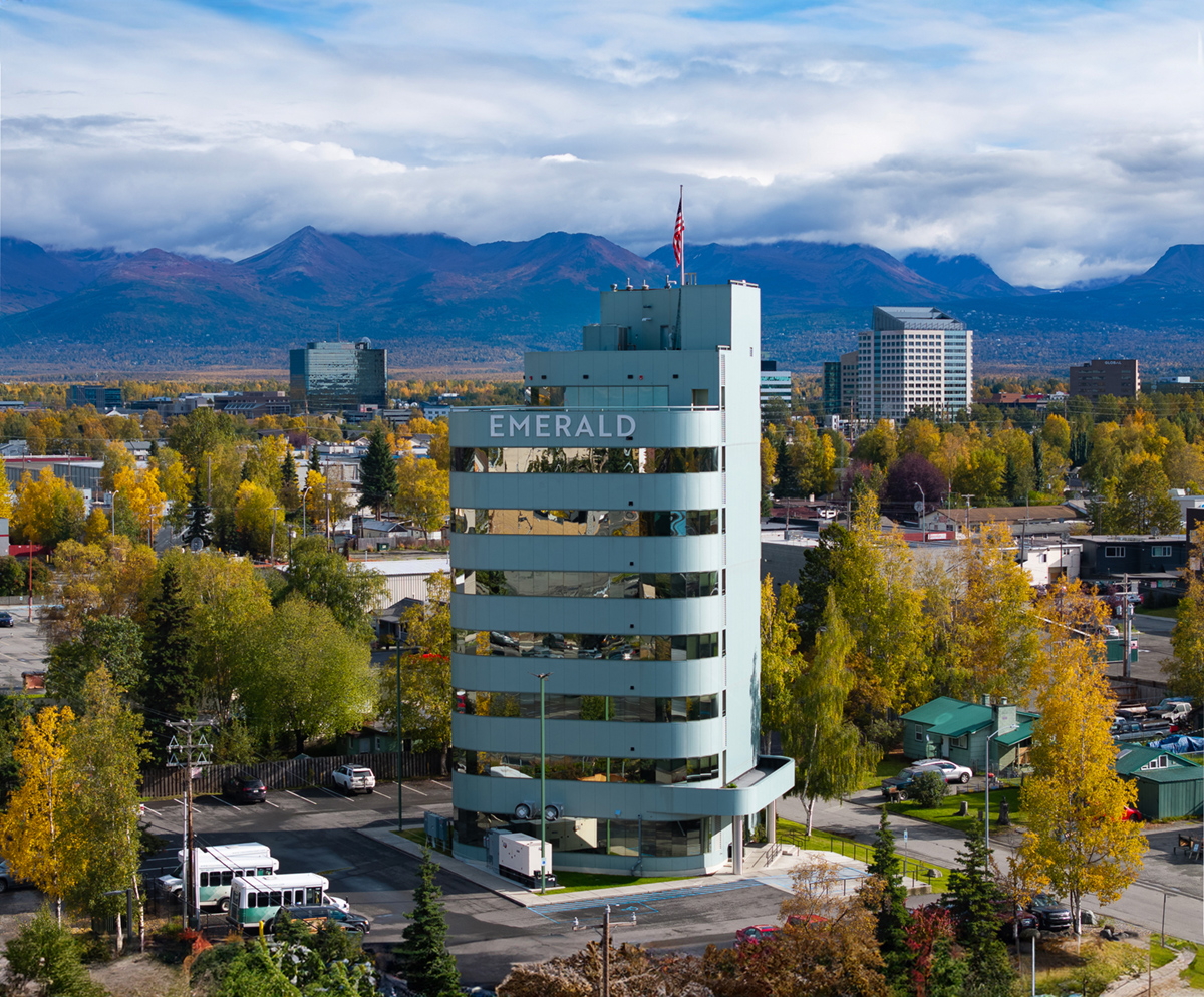 Exterior photo of the Emerald facility building in midtown anchorage with fall foliage.