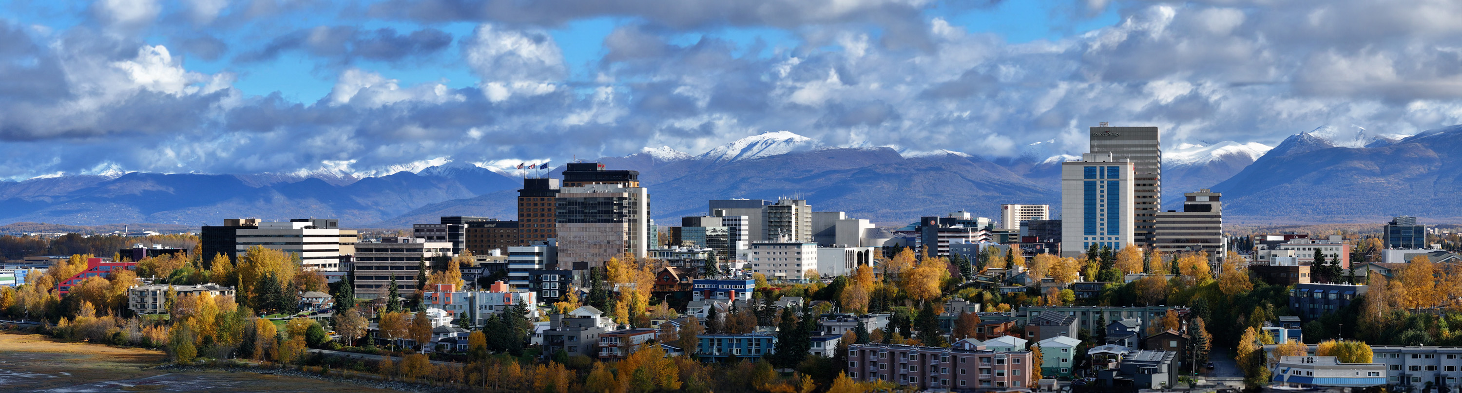 Panoramic view of downtown Anchorage with fall foliage