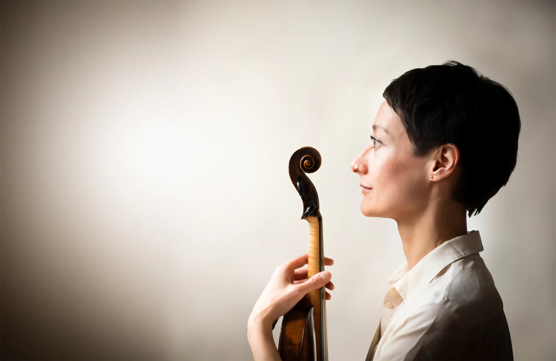 Joanna holding a violin in front of herself.