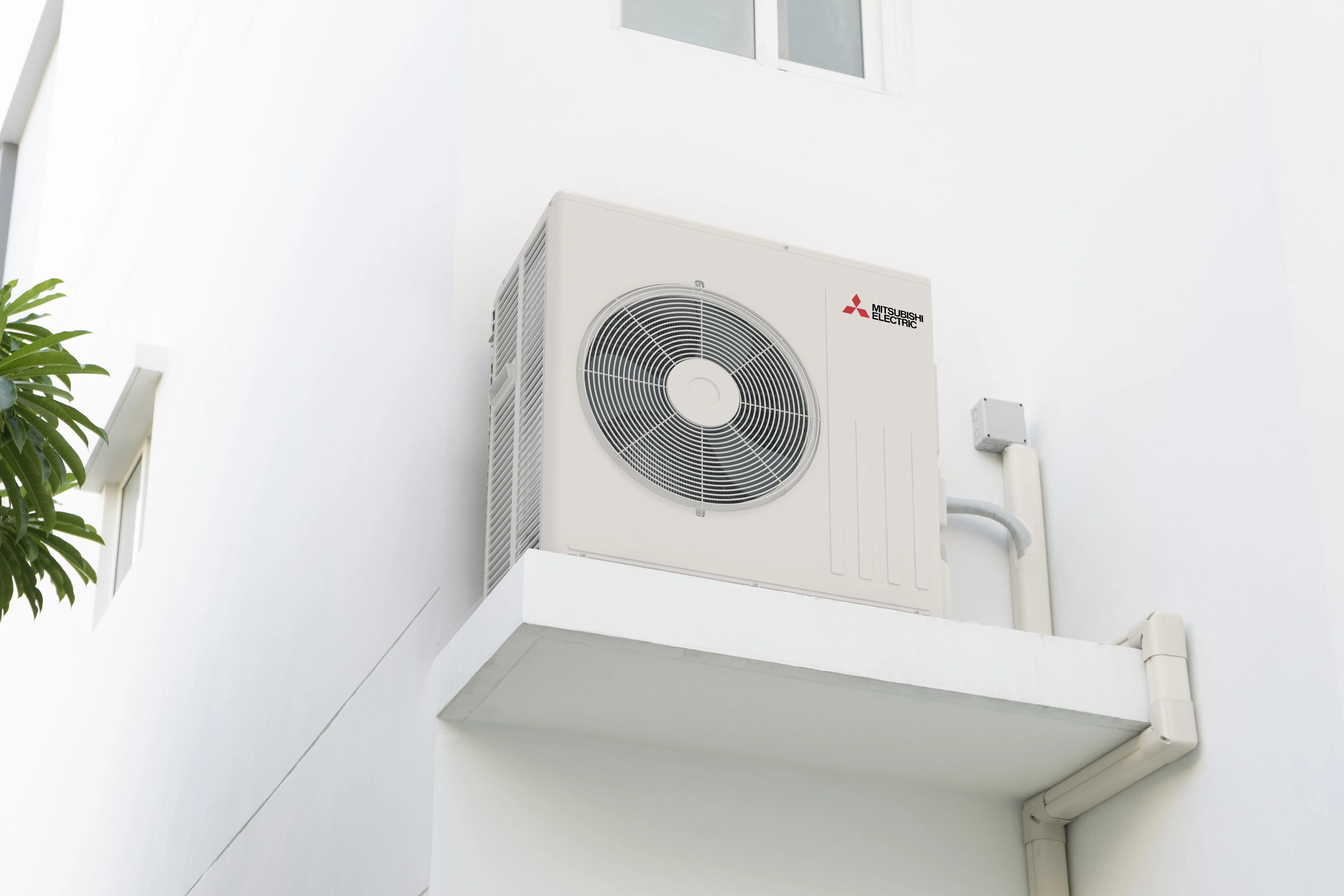A heat pump mounted on an exterior wall.