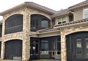 Exterior of a luxury home that has retractable screens on all patio openings