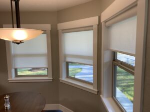 Picture of roller shades installed in a dining room.