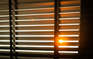 Brown shutters with the late afternoon sun shining through them