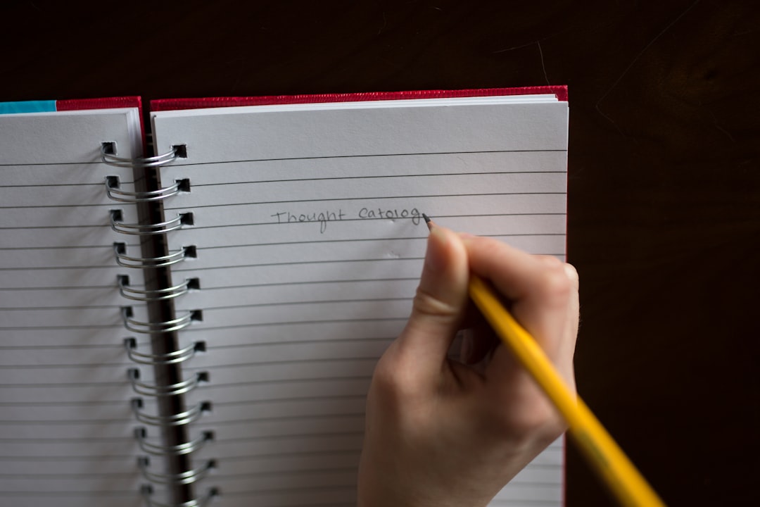 person thoughtfully writing in a notebook or on a whiteboard - Starting a private practice person thoughtfully writing in a notebook or on a whiteboard - Starting a private practice