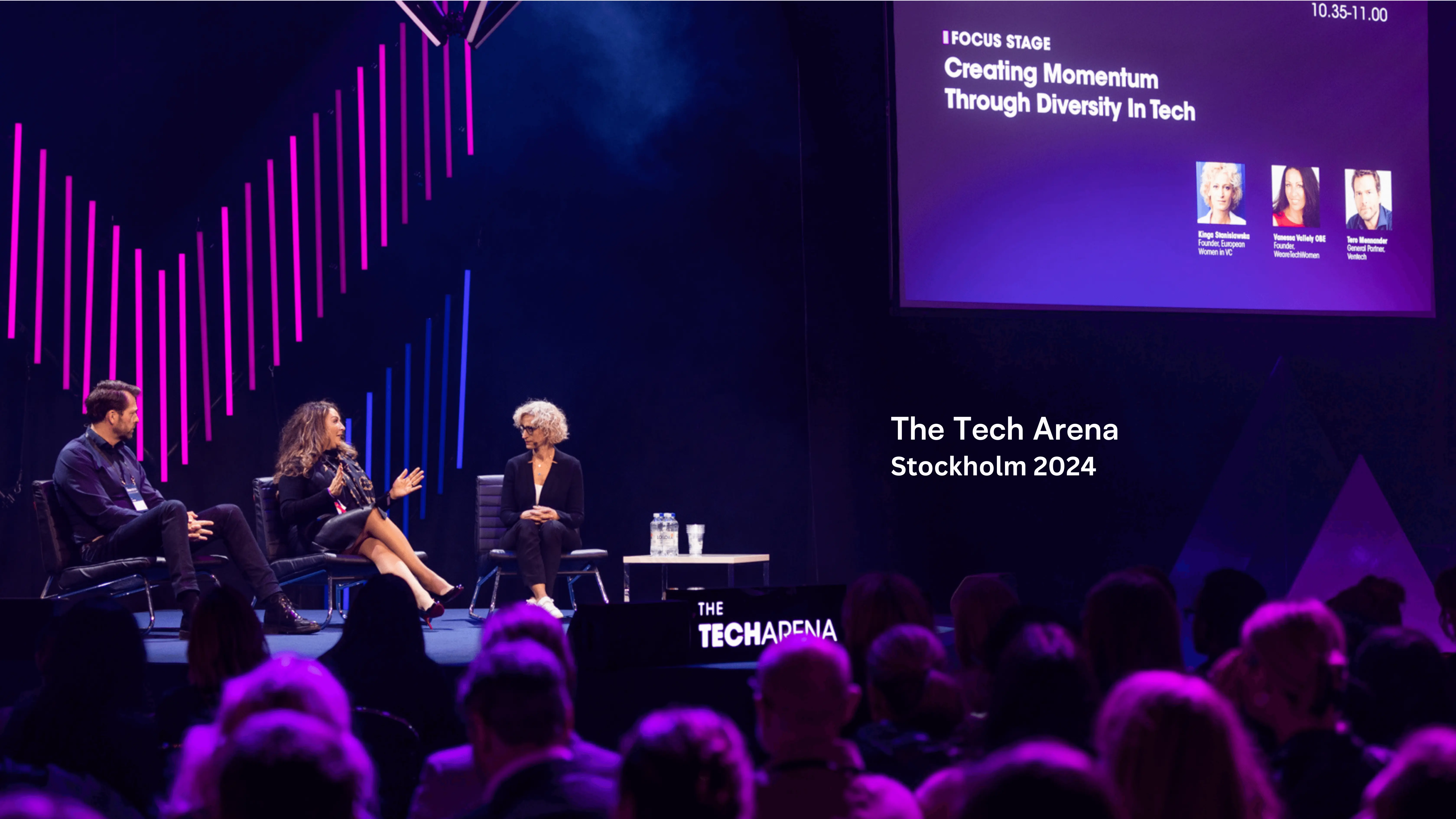 A group of people sitting on top of a stage.