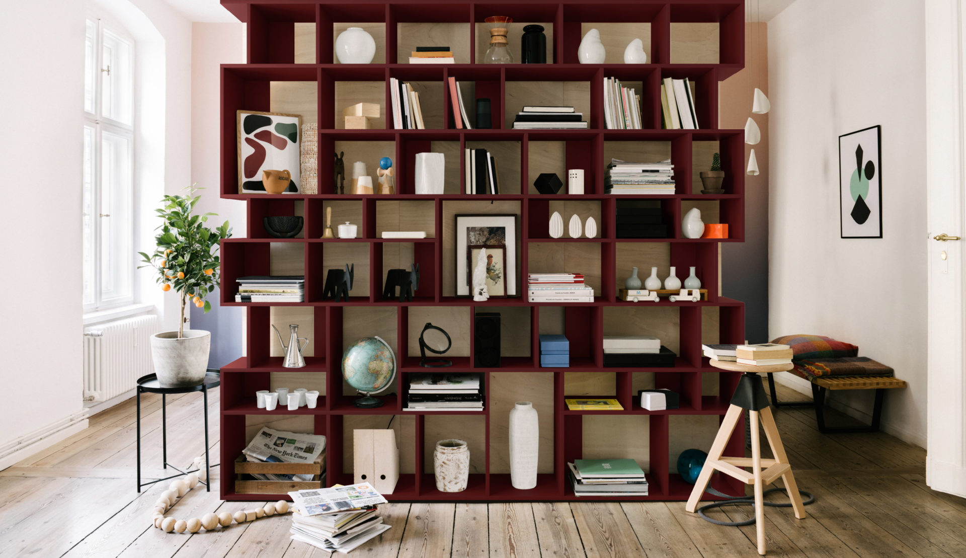 Interior room with a wall-mounted bookshelf and shelving unit