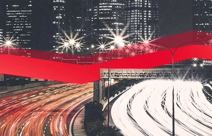 Graue Straße in einer Stadt mit einem roten Streifen durchs Bild.