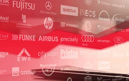 A coffee cup on a desk featuring logos of Theobald Software's partners.