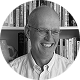 Black-and-white portrait of the author Bennett Voyles wearing a white shirt and smiling.