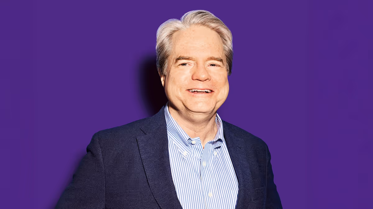Michael Morris, professor of management at Columbia Business School, pictured in front of a deep purple background.