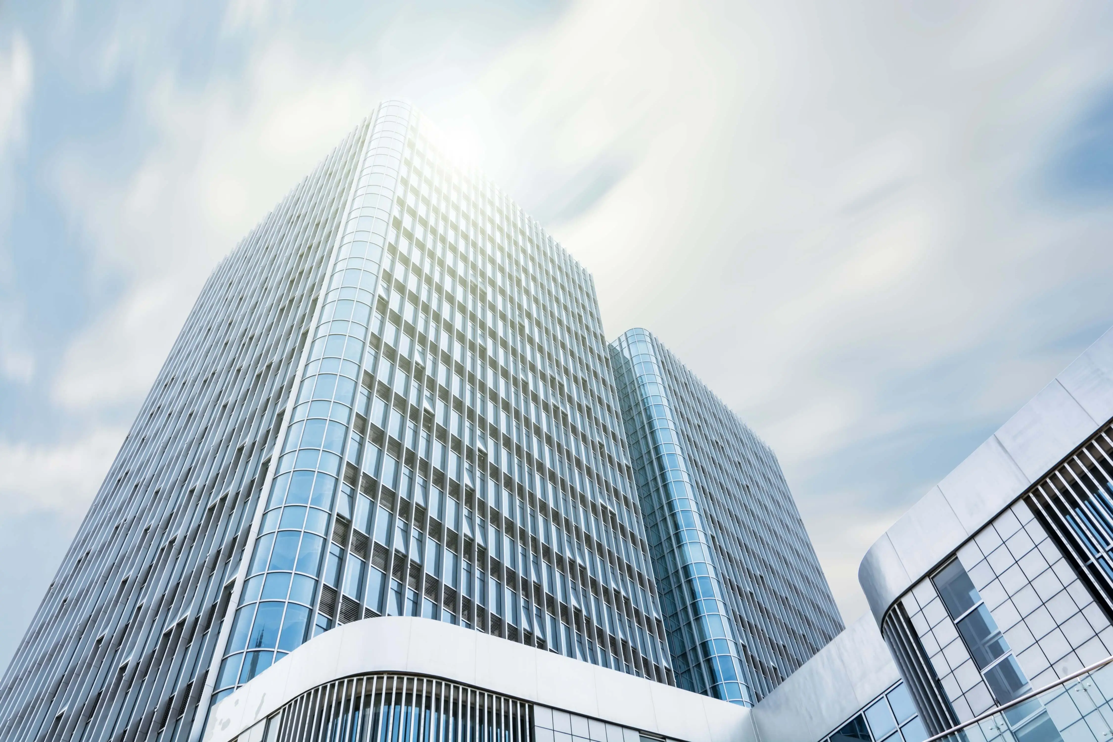 Modern, high-rise office building representing a financial institution.
