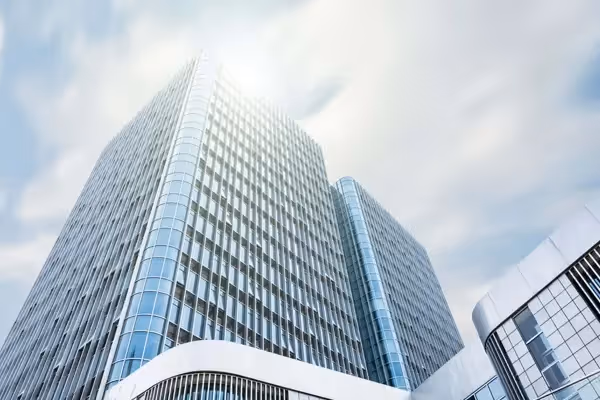 Modern, high-rise office building representing a financial institution.