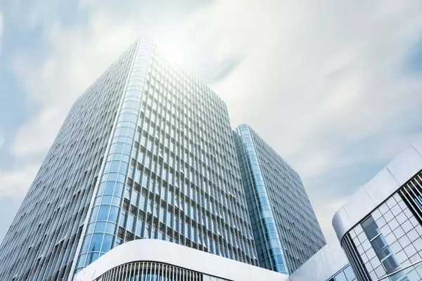 Modern, high-rise office building representing a financial institution.
