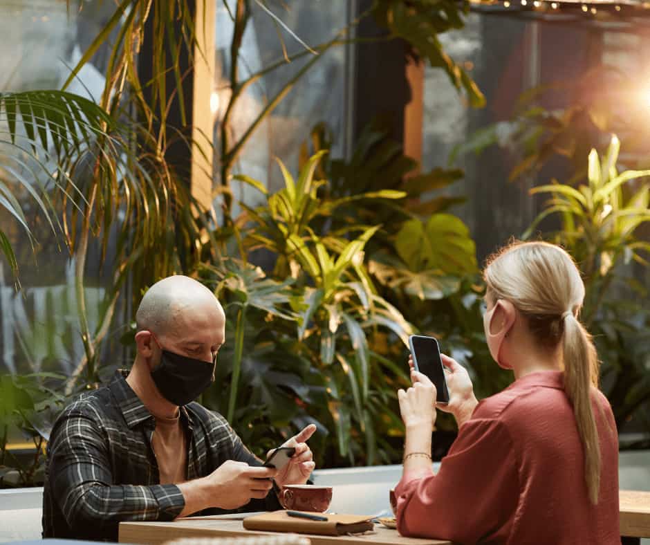 two person sitting on chair with mask
