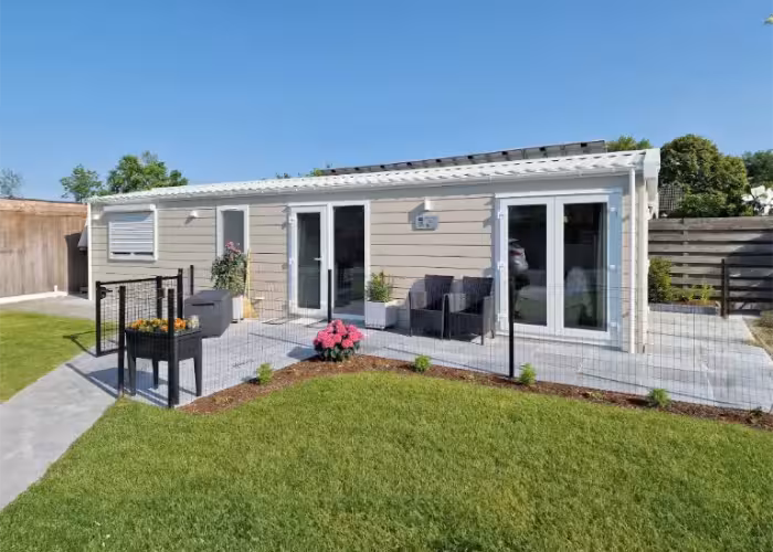 Lark Joli met terras en lage omheining naast een gazon