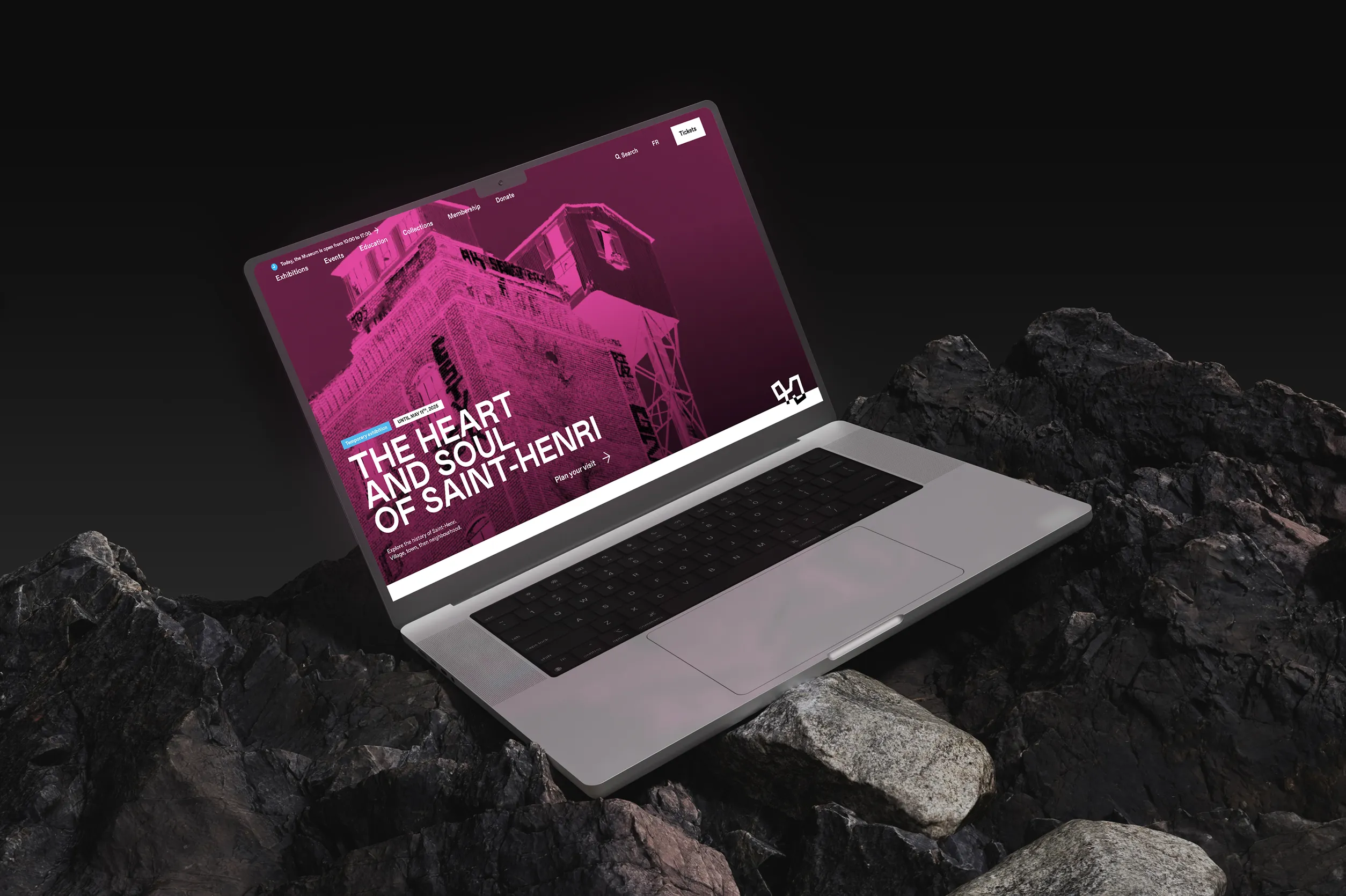 Laptop on some rocks showing pointe a calliere website