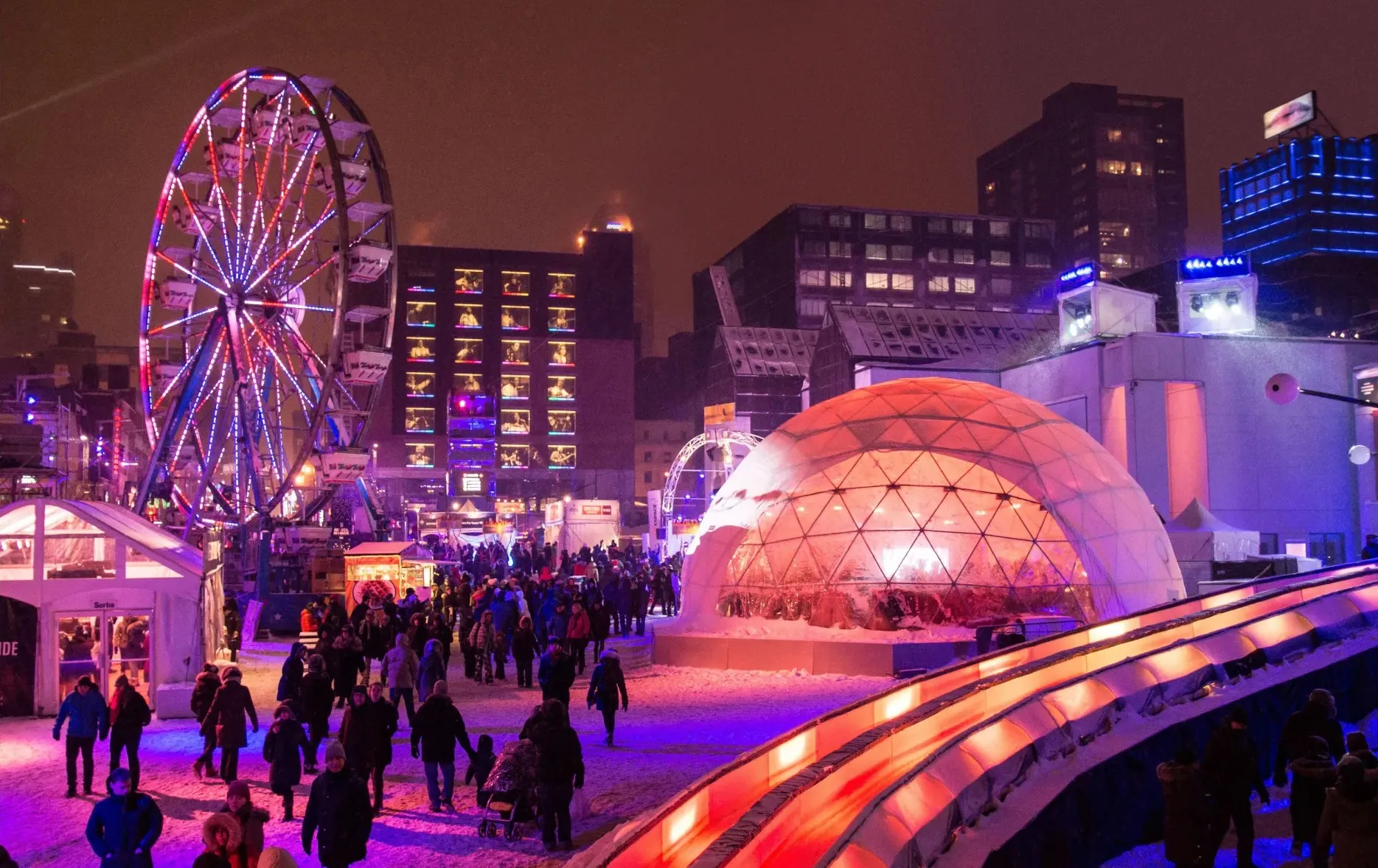 Aerial shot of montreal en lumiere festival with snow, crowd, and red, blue, and purple lights

credit: Benoit Rousseau