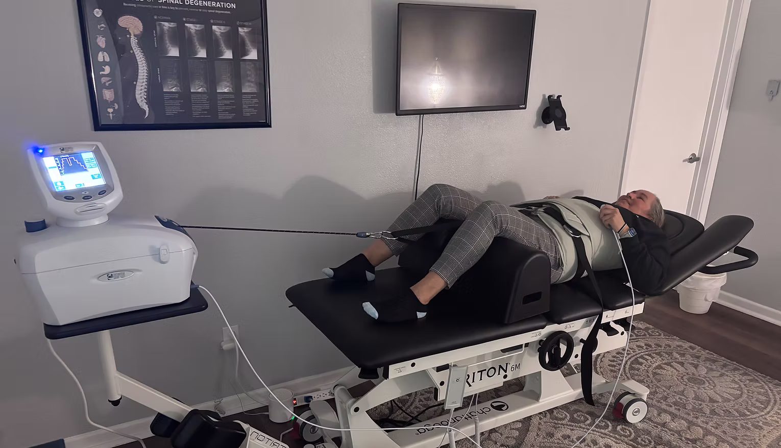 woman on a spinal decompression table in a chiropractic office.