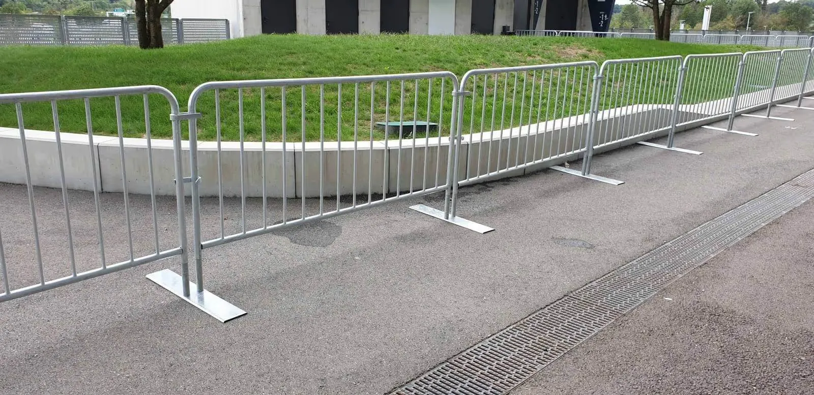 Clôtures métalliques de gestion de foule alignées pour canaliser les piétons lors d’un événement.