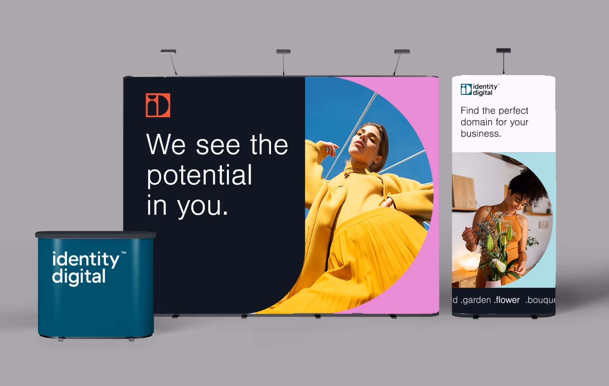 Tradeshow booth for Identity Digital featuring large banners and a desk.