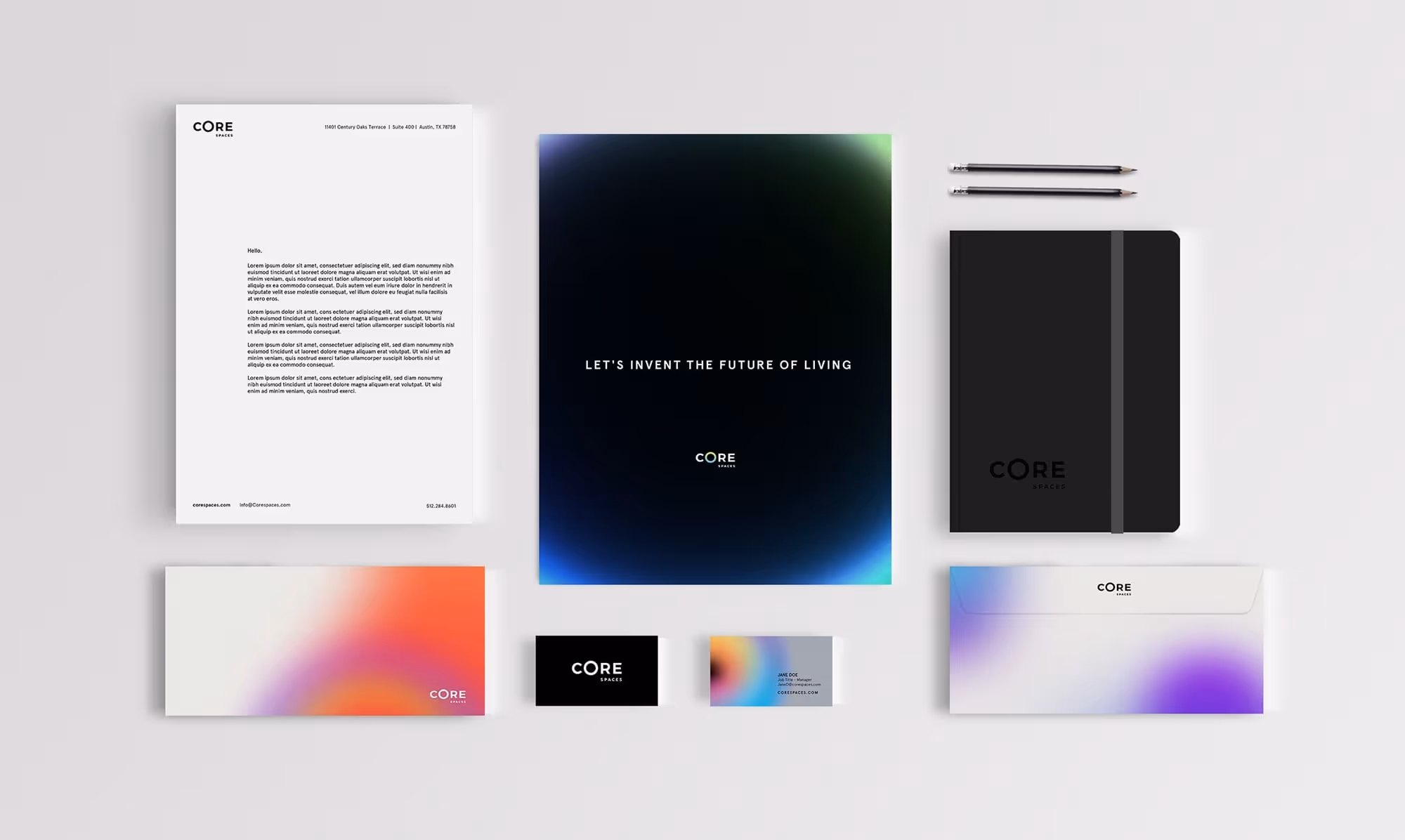 Core Spaces branded stationery set including letterhead, black notebook, two pencils, brochure, business cards, and envelopes.